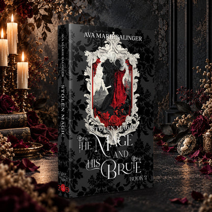 Stolen Magic (The Mage and His Brute Book 2) Special Edition Paperback by Ava Marie Salinger among candles, red roses and a cameo pendant