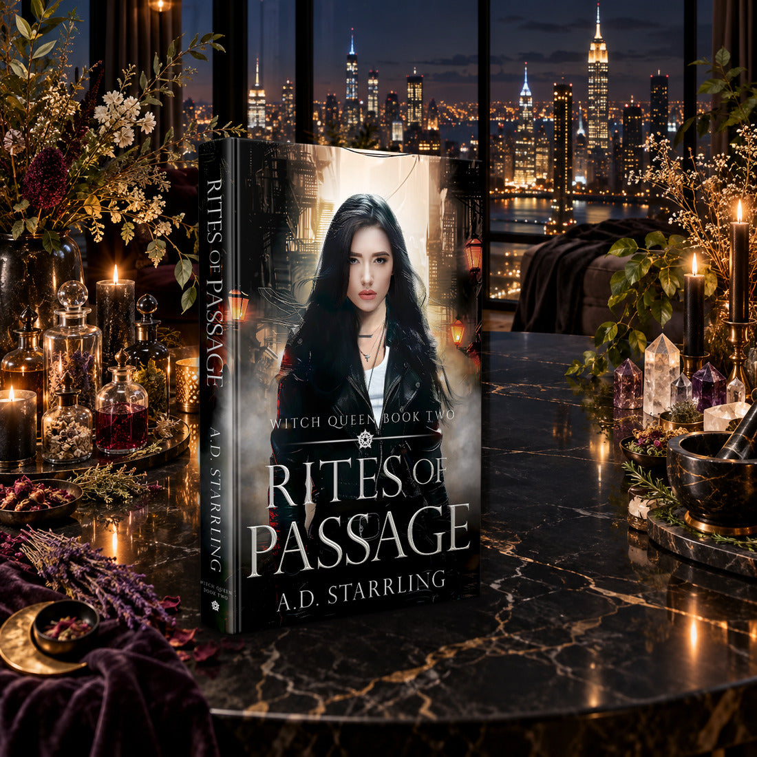 Rites of Passage (Witch Queen Book 2) Hardback by A.D. Starrling on a marble table among crystals and candles with the New York skyline at night