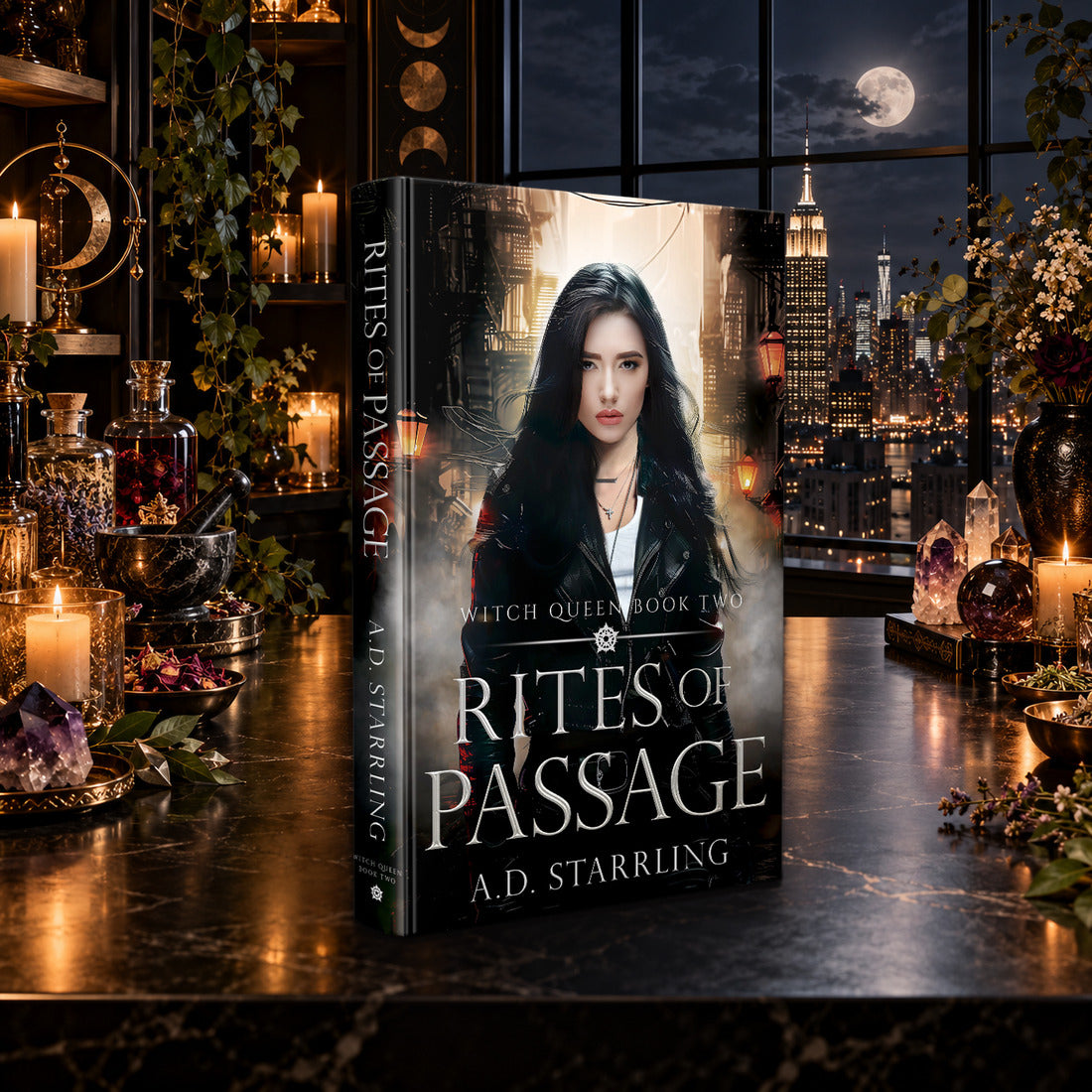 Rites of Passage (Witch Queen Book 2) Hardback by A.D. Starrling on a marble table by a moonlit window over the New York skyline