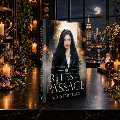 Rites of Passage (Witch Queen Book 2) Hardback by A.D. Starrling on a marble table by a moonlit window over the New York skyline