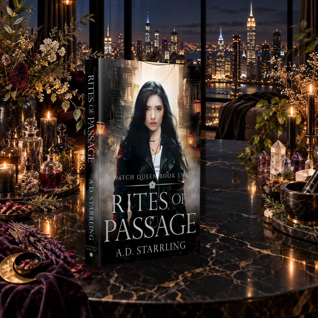 Rites of Passage (Witch Queen Book 2) Paperback by A.D. Starrling on a marble table among crystals and candles with the New York skyline at night