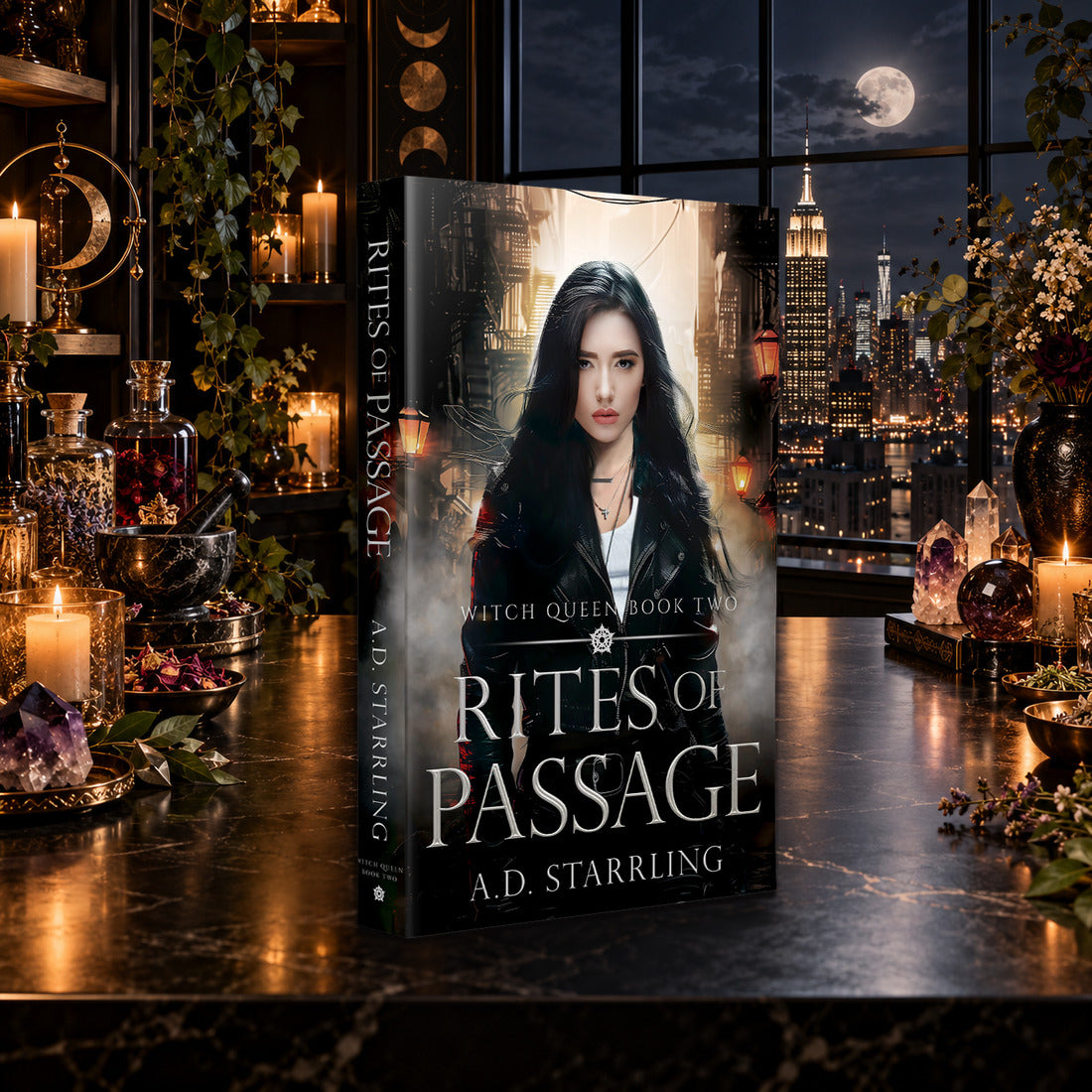 Rites of Passage (Witch Queen Book 2) Paperback by A.D. Starrling on a marble table by a moonlit window over the New York skyline
