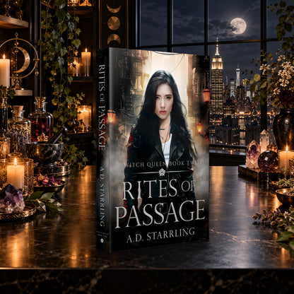Rites of Passage (Witch Queen Book 2) Paperback by A.D. Starrling on a marble table by a moonlit window over the New York skyline