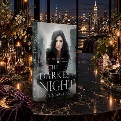 The Darkest Night (Witch Queen Book 1) Paperback by A.D. Starrling on a marble table among crystals and candles with the New York skyline at night