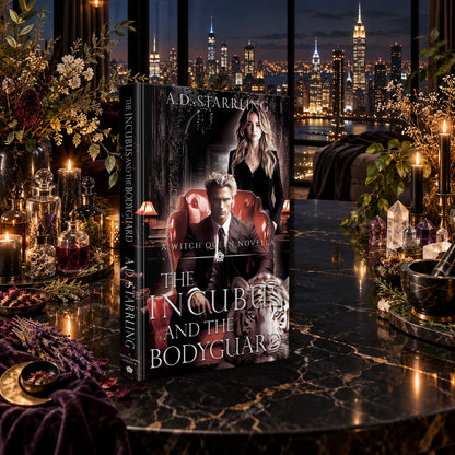 The Incubus and the Bodyguard (A Witch Queen Novella) Hardback by A.D. Starrling on a marble table among crystals and candles with the New York skyline at night