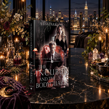 The Incubus and the Bodyguard (A Witch Queen Novella) Paperback by A.D. Starrling on a marble table among crystals and candles with the New York skyline at night