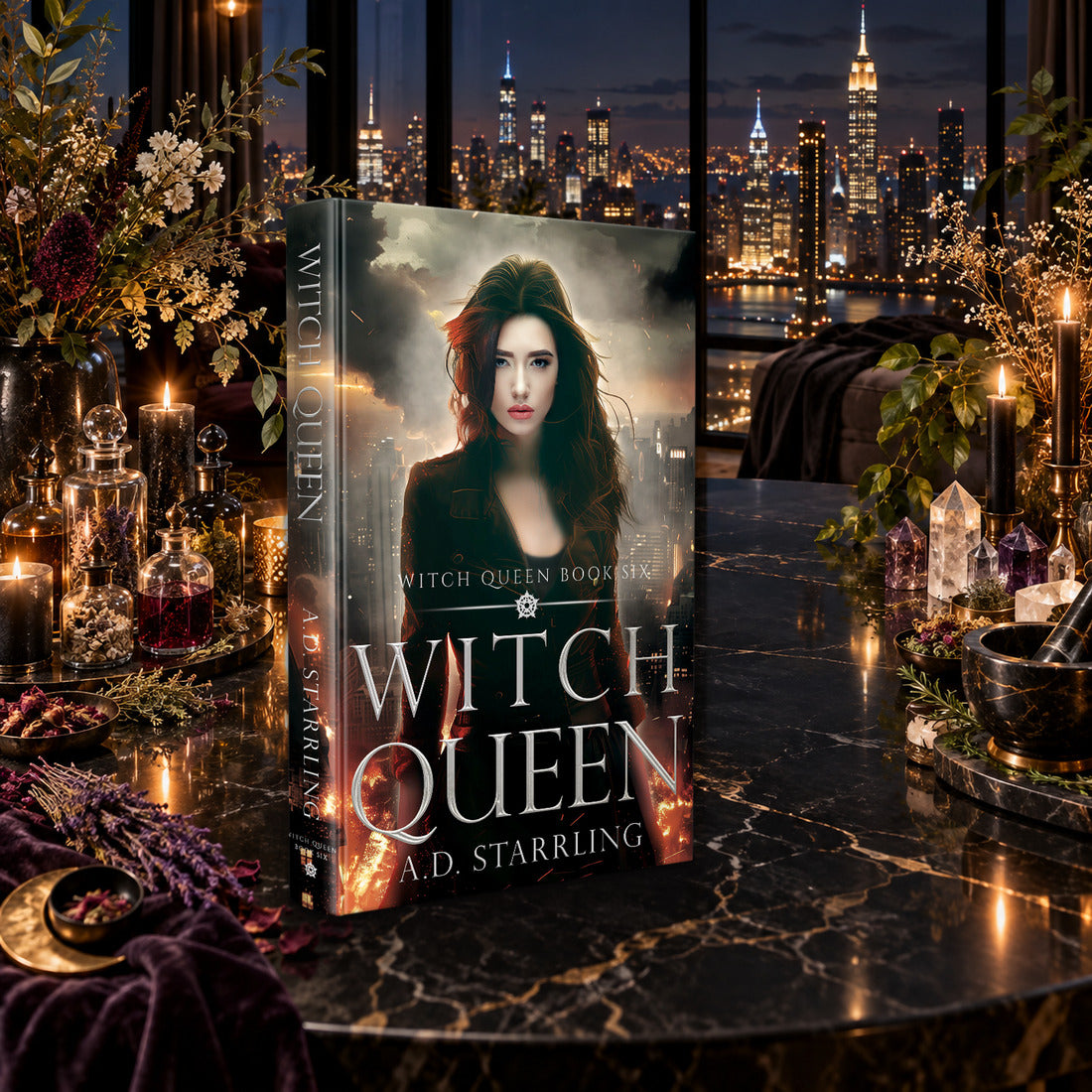 Witch Queen (Witch Queen Book 6) Hardback by A.D. Starrling on a marble table among crystals and candles with the New York skyline at night