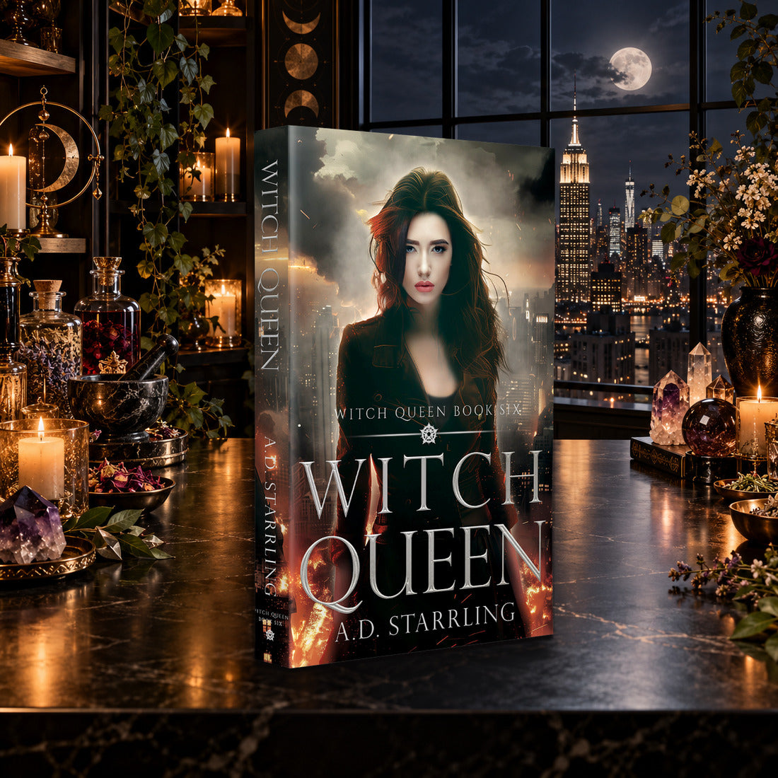 Witch Queen (Witch Queen Book 6) Paperback by A.D. Starrling on a marble table by a moonlit window over the New York skyline