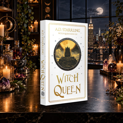 Witch Queen (Witch Queen Book 6) Special Edition Paperback by A.D. Starrling on a marble table by a moonlit window over the New York skyline
